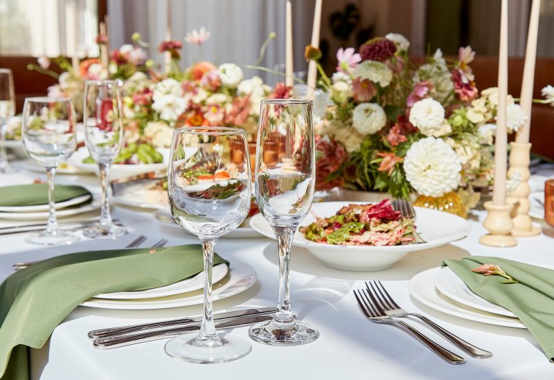 Aesthetic table setting with candles and flowers decorations. Restaurant chamber event