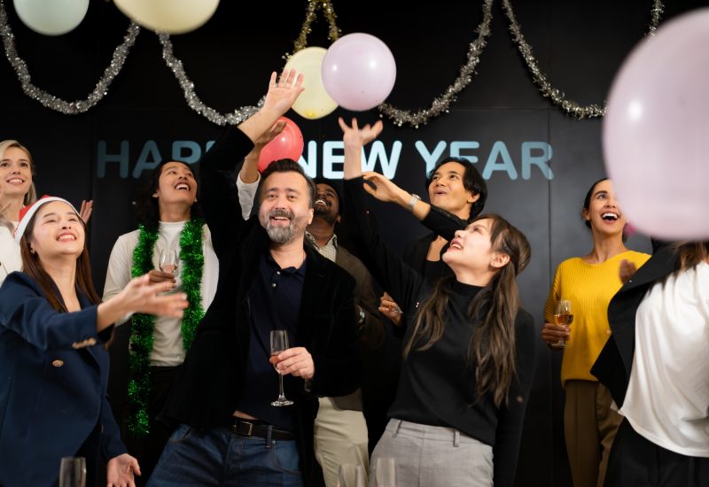 Group of friends celebrating New Year and having fun at corporate party.
